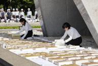 Hiroshima city officials air out books listing the names of victims of the 1945 U.S. atomic bombing of the western Japanese city after removing them from a stone chamber beneath the cenotaph for the victims at the Peace Memorial Park in Hiroshima on May 15, 2024. The officials also turned each page to check the condition of the 125 books, which contain a total of 339,227 names, ahead of the rainy season. (Kyodo) ==Kyodo