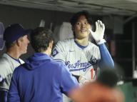 Los Angeles Dodgers designated hitter Shohei Ohtani (R) talks with a coach in the dugout during a baseball game against the San Francisco Giants at Oracle Park in San Francisco on May 14, 2024. (Kyodo) ==Kyodo