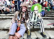 London, UK. Cosplayers (costume player) attendees as Captain Jack Sparrow and Beetlejuice at the MCM Comic Con London. Day 3. ExCel London. 26th May 2024. Ref:LMK11-S260524-001 Steve Bealing/Landmark Media
