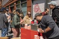 Hundreds of people line up for dollar scoops of Salt & Straw ice cream at a cart outside of their future store in Greenwich Village in New York on Friday, April 26, 2024. The popular West Coast ice cream seller will be opening two stores in New York in the summer os 2024.( Â Richard B. Levine