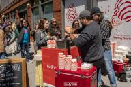 Hundreds of people line up for dollar scoops of Salt & Straw ice cream at a cart outside of their future store in Greenwich Village in New York on Friday, April 26, 2024. The popular West Coast ice cream seller will be opening two stores in New York in the summer os 2024.( Â Richard B. Levine