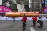 âHot Dog in the Cityâ, by the artists Jen Catron and Paul Outlaw in Times Square in New York on Tuesday, April 30, 2024. The 65 foot long animatronic hot dog sculpture raises up and ejaculates confetti at noon each day. The installation will be on display until June 13.(Â Richard B. Levine