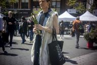 A shopper with her asparagus purchase in the busy Union Square Greenmarket in New York on Wednesday, May 1, 2024 ( Richard B. Levine