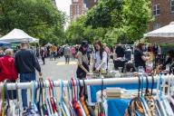 Shoppers search for bargains at the humongous annual Penn South Flea Market in the New York neighborhood of Chelsea on Saturday, May 18, 2024. The flea market appears like Brigadoon, only once every year, and the residents of the 20 building Penn South cooperative have a closet cleaning extravaganza. Shoppers from around the city come to the flea market which attracts thousands of visitors. (Â Richard B. Levine