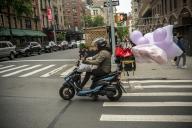 Deliveryman delivers balloons from Party City on his scooter in Greenwich Village in New York on Saturday, May 18, 2024. (Â Richard B. Levine