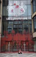 Activists from climate protest group This Is Rigged have daubed the UK Government office Queen Elizabeth House with red paint. Protestors scaled the office building with is off the Royal Mile with one apparently gluing herself to the pavement 
