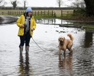 Debra Robertson with Dougie at Ashby Cum Fenby where flooding has effected the village after Storm Henk North East Lincolnshire 3rd January