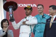 SUZUKA, JAPAN - OCTOBER 07: Lewis Hamilton, Mercedes AMG F1, 1st position, celebrates his win on the podium with his trophy during the Japanese GP at Suzuka on October 07, 2018 in Suzuka, Japan. (Photo by Steve Etherington / LAT Images)