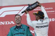 SUZUKA, JAPAN - OCTOBER 07: Lewis Hamilton, Mercedes AMG F1, 1st position, on the podium spraying champagne during the Japanese GP at Suzuka on October 07, 2018 in Suzuka, Japan. (Photo by Steve Etherington / LAT Images)