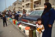 March 17, 1991 - Kuwait City, Kuwait: Palestinians wait for water to be delivered to their neighborhood. Kuwaiti authorities make the Palestinians wait for water because PLO Chairman Yassir Arafat supported Saddam Hussein in his invasion of Kuwait. Many also participated in the looting carried out by Iraqi troops. 200,000 Palestinians who fled the war were not allowed back in to Kuwait, and the remaining 200,000 were given one week to leave the country, losing their jobs and homes. (Allan Tannenbaum / Polaris