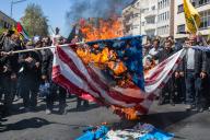 April 5, 2024 - Tehran, Iran: Attendees on the annual Quds day rally are burning flags of US and Israe. Thousands of people chanted against Israel and the United States at today