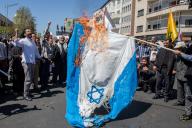 April 5, 2024 - Tehran, Iran: Attendees on the annual Quds day rally are burning a flag of Israel. Thousands of people chanted against Israel and the United States at today