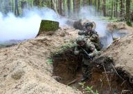 ZHYTOMYR REGION, UKRAINE - APRIL 23, 2024 - Soldiers practise clearing a trench from the enemy in pairs during the drills of the Liut (Fury) Brigade of the National Police of Ukraine at a training area in Zhytomyr region, northern Ukraine. (Ukrinform\/POLARIS