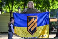 ZAPORIZHZHIA, UKRAINE - MAY 5, 2024 - A woman holds a flag during a rally celebrating the 10th anniversary of the 12th Azov Assault Brigade of Ukraineâs National Guard, Zaporizhzhia, southeastern Ukraine. (Ukrinform\/POLARIS