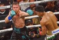 LAS VEGAS, NEVADA - MAY 04, 2024: Saul \'Canelo\' Alvarez (in black &amp; turquoise short) from Guadalajara, Mexico and Jaime Munguia (in gold &amp; white short) from Tijuana, Mexico exchange punches during their super middleweight undisputed world titles of the Premiere Boxing Championship on Saturday night at the T-Mobile Arena in Las Vegas, Nevada, United States on May 04, 2024. Canelo was victorious. (Tom Donoghue\/POLARIS