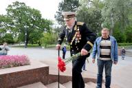 ODESA, UKRAINE - MAY 9, 2024 - A senior man lays flowers at the Monument of the Unknown Sailor, Odesa, southern Ukraine. (Ukrinform/POLARIS