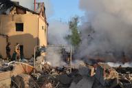 KHARKIV, UKRAINE - MAY 10, 2024 - Rescuers are seen at work at a house after a Russian missile attack, Kharkiv, northeastern Ukraine. On the night of 10 May, Russian invaders attacked Kharkiv with an S-300 missile. A child aged 11 and a 72-year-old woman were injured as a result of the attack on the private sector. Three houses were on fire, two of them were destroyed and one was damaged. In total, 26 buildings were destroyed, and more than 300 windows were smashed. (Ukrinform/POLARIS