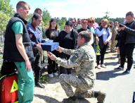 KYIV REGION, UKRAINE - MAY 10, 2024 - A serviceman presents a box to the relatives of the soldier Ivan Budnyk, who died on May 1 in Pokrovsk district, Donetsk region, as a result of mortar shelling, during a funeral ceremony on the Alley of Memory of the Defenders of Ukraine, Irpin, Kyiv region, northern Ukraine. (UKRINFORM/POLARIS