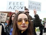KYIV, UKRAINE - MAY 12, 2024 - A woman wears sunglasses with "Free Azov" inscription on them made with a marker during the action in support of the captured defenders of Mariupol "Donât be silent! Captivity Kills" on Obolonska embankment, Kyiv, capital of Ukraine. (UKRINFORM/POLARIS