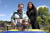 KYIV REGION, UKRAINE - MAY 10, 2024 - Female relatives of the soldier Yevhen Slyvka (call sign "Shaman"), who died on April 16, 2024, in a battle in Donetsk region, look at the urn with his ashes during a funeral ceremony on the Alley of Memory of the Defenders of Ukraine, Irpin, Kyiv region, northern Ukraine. (UKRINFORM/POLARIS