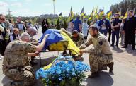 KYIV REGION, UKRAINE - MAY 10, 2024 - Servicemen cover the coffin with the national flag of Ukraine during the funeral ceremony for soldier Ivan Budnyk, who died on May 1 in Pokrovsk district, Donetsk region, as a result of mortar shelling, on the Alley of Memory of the Defenders of Ukraine, Irpin, Kyiv region, northern Ukraine. (UKRINFORM/POLARIS
