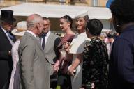 Image Licensed to i-Images / Polaris) Picture Agency. 15/05/2024. London, United Kingdom: King Charles III talking to model Rosie Huntington-Whiteley at a Buckingham Palace Garden Party in London. ( i-Images / Polaris) 