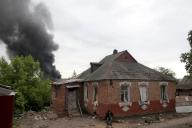 KHARKIV, UKRAINE - MAY 17, 2024 - A pillar of smoke rises from behind a house following the shelling of Russian troops, Kharkiv, northeastern Ukraine. (Ukrinform/POLARIS