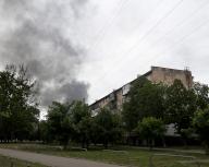 KHARKIV, UKRAINE - MAY 17, 2024 - A pillar of smoke rises from behind an apartment block after the shelling of Russian troops, Kharkiv, northeastern Ukraine. (Ukrinform/POLARIS