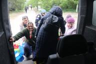 KHARKIV REGION, UKRAINE - MAY 17, 2024 - Elderly women get on a minibus during the evacuation from Vovchansk which is under constant Russian shelling, Kharkiv region, northeastern Ukraine. (Ukrinform/POLARIS