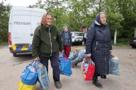 KHARKIV REGION, UKRAINE - MAY 17, 2024 - Elderly women carry bags with their belongings during the evacuation from Vovchansk which is under constant Russian shelling, Kharkiv region, northeastern Ukraine. (Ukrinform/POLARIS