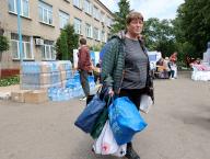 KHARKIV, UKRAINE - MAY 19, 2024 - A woman holds bags at a centre for people evacuated from the Kharkiv region, northeastern Ukraine. (UKRINFORM/POLARIS