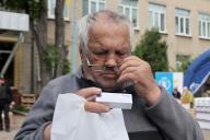 KHARKIV, UKRAINE - MAY 19, 2024 - An elderly man reads the text on a medication pack at a centre for people evacuated from the Kharkiv region, northeastern Ukraine. (UKRINFORM/POLARIS