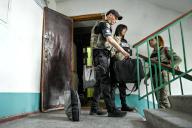 STEPNOHIRSK, UKRAINE - MAY 21, 2024 - A police officer (L) helps to evacuate a family who live in an apartment block opposite the settlement council building which has been hit by a Russian guided bomb, Stepnohirsk, Zaporizhzhia region, southeastern Ukraine. (Ukrinform/POLARIS