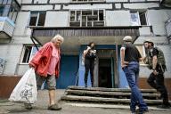 STEPNOHIRSK, UKRAINE - MAY 21, 2024 - People are pictured outside an apartment block during the evacuation of a family living opposite the local council building hit by a Russian guided bomb, Stepnohirsk, Zaporizhzhia region, southeastern Ukraine. (Ukrinform/POLARIS