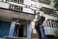 STEPNOHIRSK, UKRAINE - MAY 21, 2024 - A man and woman are pictured outside an apartment block during the evacuation of a family living opposite the local council building hit by a Russian guided bomb, Stepnohirsk, Zaporizhzhia region, southeastern Ukraine. (Ukrinform/POLARIS
