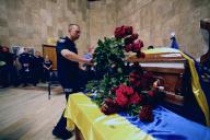 KHARKIV, UKRAINE - MAY 24, 2024 - Police officers pay their last respects to Major Andrii Ladyka, 41, who was involved in the evacuation of civilians from Vovchansk, Kharkiv region, and died when his police car was attacked by a Russian drone on May 22, Kharkiv, northeastern Ukraine. (Ukrinform/POLARIS