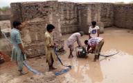 MOHENJO DARO, PAKISTAN, AUG 26: Laborers are draining out accumulated rain water caused damage to the World Heritage monuments in Mohenjo Daro on Wednesday, August 26, 2020. (Jamal Dawoodpoto/PPI Images