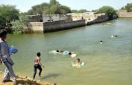 HYDERABAD, PAKISTAN, SEP 21: Children are enjoying bath at a flooded water located on Latifabad No.04 in Hyderabad on Wednesday, September 21, 2022. (Sajjad Zaidi/PPI Images