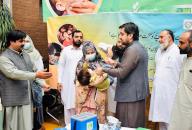 PESHAWAR, PAKISTAN, APR 25: Deputy Commissioner of Peshawar, Afaq Wazir administrating polio-vaccine drops to a child during inauguration ceremony of seven days anti- polio immunization campaign, in Peshawar on Thursday, April 25, 2024. (PPI Images