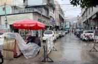 QUETTA, PAKISTAN, APR 25: Vendor covers his stall with plastic sheets to save himself from rain during the downpour in Quetta on Thursday, April 25, 2024. (Sami Khan\/PPI Images