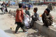 QUETTA, PAKISTAN, APR 26: Garbage pickers are sitting on the sidewalk as they chat with each other, at Satellite Town in Quetta on Friday, April 26, 2024. (Sami Khan\/PPI Images