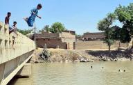 DADU, PAKISTAN, MAY 16: Boys are jumping into canal for swimming and trying to cool themselves to beat the heat of scorching sun during hot weather of summer season, in Dadu on Thursday, May 16, 2024. (Samad Jamal/PPI Images