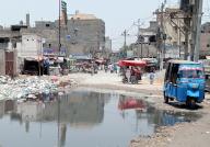 KARACHI, PAKISTAN, MAY 16: Commuters are facing difficulties in transportation due to wreckage condition of road and sewerage water caused by poor sewerage system, showing negligence of concerned authorities, located on Korangi area in Karachi on Thursday, May 16, 2024. (S.Imran Ali/PPI Images