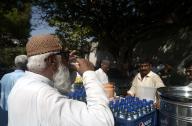 KARACHI, PAKISTAN, MAY 16: People are drinking juice to quench their thirst as demand of juices increased in city during scorching hot weather, outside Supreme Court Registry in Karachi on Thursday, May 16, 2024. (S.Imran Ali/PPI Images