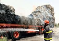 MULTAN, PAKISTAN, MAY 17: View of huge fire flames rise from burning trailer loaded with card boards that caught fire due to high temperature while fire brigade officials are busy in exhausting fire during rescue operation, in Multan on Friday, May 17, 2024. (Abdul Sattar/PPI Images