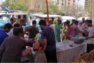 KARACHI, PAKISTAN, MAY 17: People are quenching their thirst by chilled juice to beat the heat of scorching sun during the weather of summer season, at a relief camp of heat stroke organized by Markazi Muslim League (PMML), at Gulberg area in Karachi on Friday, May 17, 2024. (S.Imran Ali/PPI Images