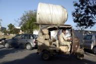 KARACHI, PAKISTAN, MAY 17: A rickshaw driver carries huge water tank on his rickshaw passing through a road violating traffic rules, showing the negligence of concerned authority, at Do Talwar in Karachi on Friday, May 17, 2024. (S.Imran Ali/PPI Images