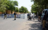 KARACHI, PAKISTAN, MAY 18: Police officials stand alert to avoid untoward incidents while road seen closed that lead towards Governor House due to expectation of protest demonstrations against price hike of essential commodities and inflation, in Karachi on Saturday, May 18, 2024. (Bahzad Khan/PPI Images
