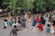 LAHORE, PAKISTAN, MAY 19: A large number of people are enjoying bath to beat the heat of scorching sun during a hot day of summer season, at a Canal near Jallo Mor in Lahore on Sunday, May 19, 2024. (Babar Shah/PPI Images