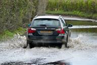 Cars drive through the water logged country lanes after a night of heavy rain., Credit:Geoffrey Swaine \/ Avalon